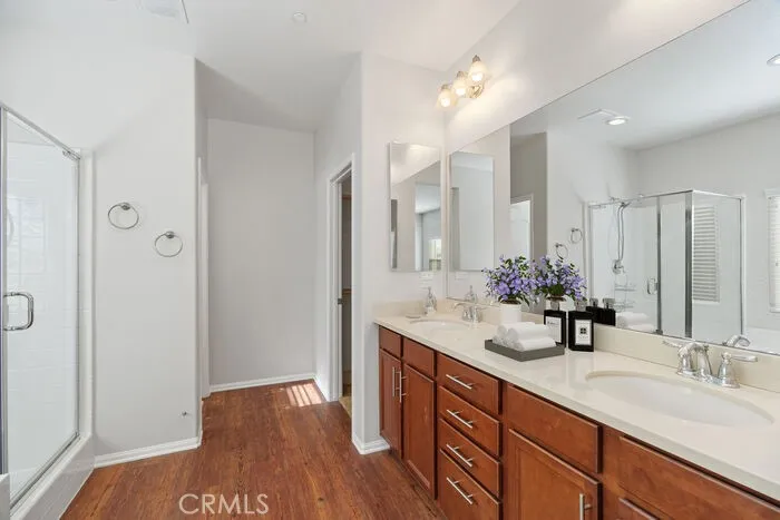 The primary bathroom offers dual vanities, a soaking tub, walk-in shower and a large walk-in closet
