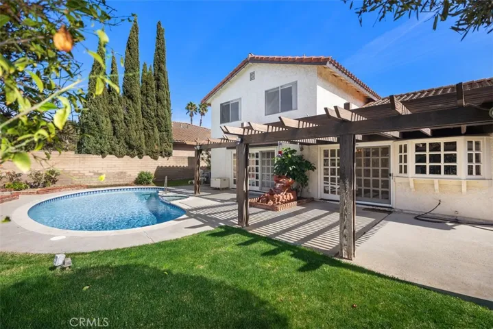 Back of the house is great for entraining with sweeping views, pool, jacuzzi, hard & soft scape, fruit tree, and more room to develop more.