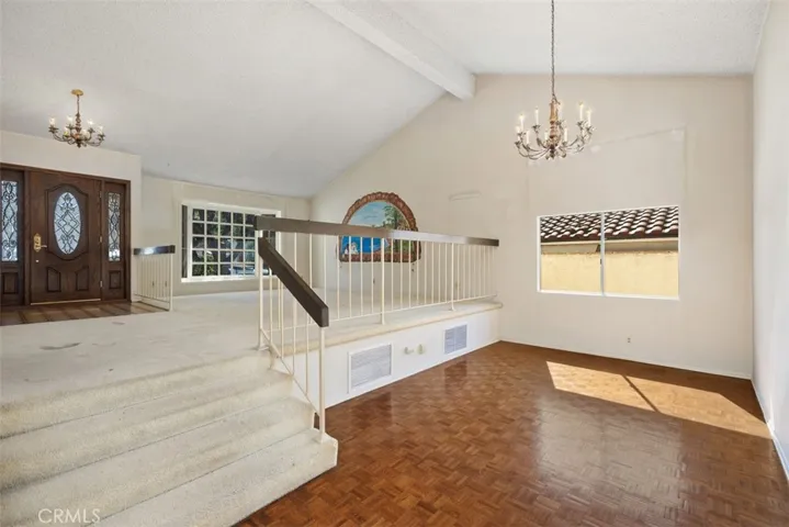 Expansive living room/dining room with cathedral ceilings could be opened up into kitchen/family room creating even more expansive open concept living.
