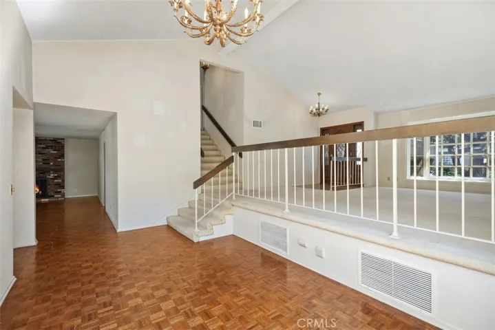 Expansive living room/dining room with cathedral ceilings could be opened up into kitchen/family room creating even more expansive open concept living.