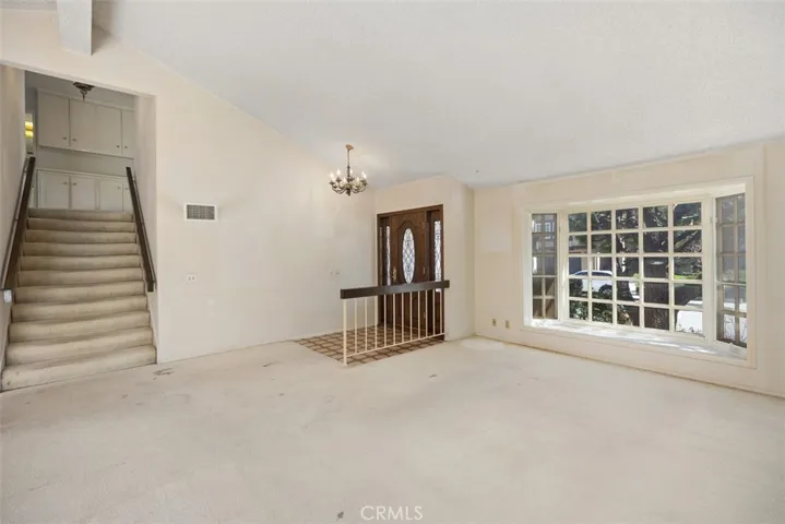 Expansive living room/dining room with cathedral ceilings could be opened up into kitchen/family room creating even more expansive open concept living.
