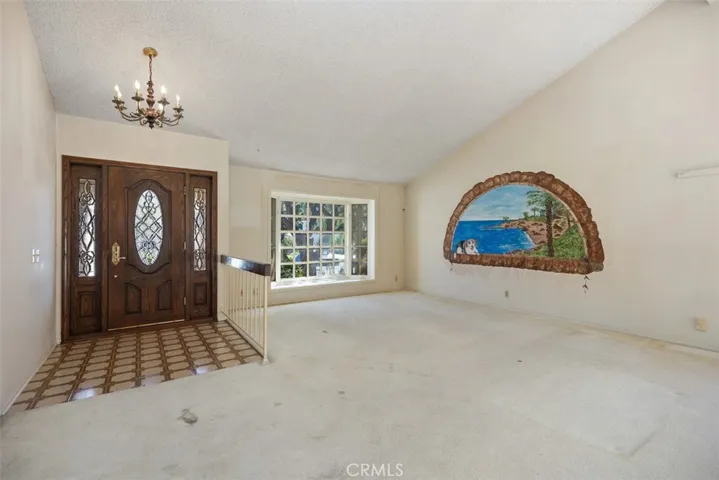 Expansive living room/dining room with cathedral ceilings could be opened up into kitchen/family room creating even more expansive open concept living.