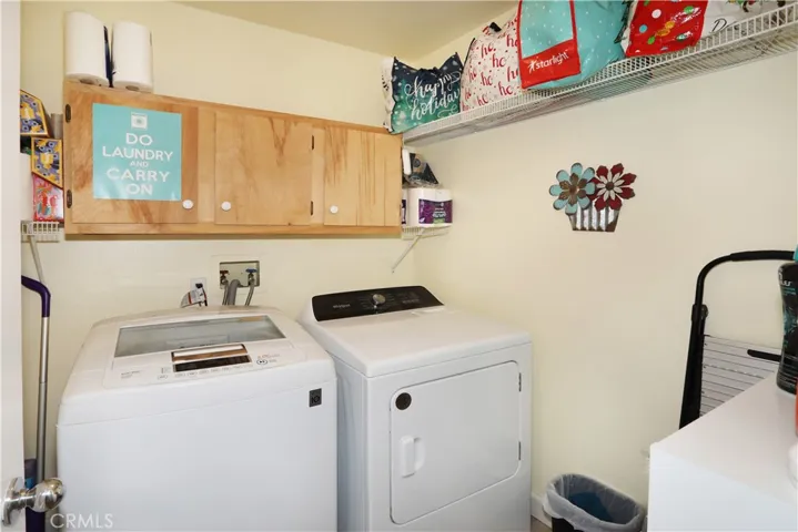 Indoor Laundry room with lots of storage,