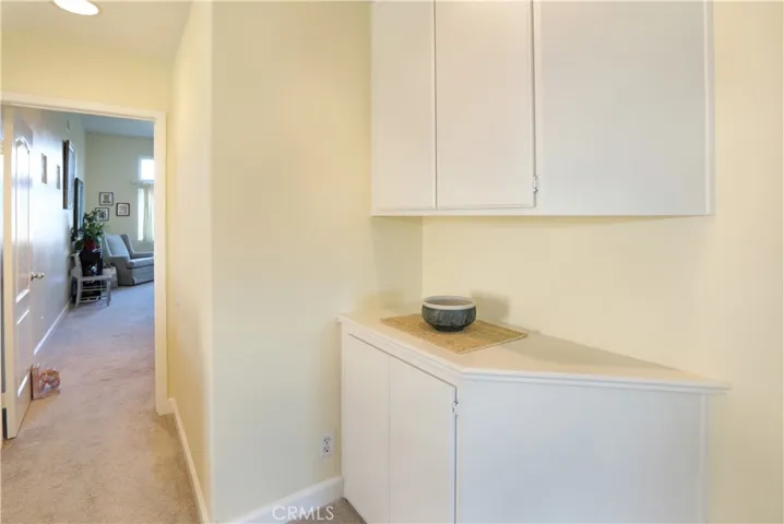 Leaving the two bedrooms, heading to the Primary Suite, storage on right