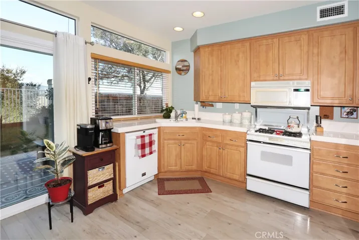 Kitchen, view of the back yard, patio, and the California mountains
