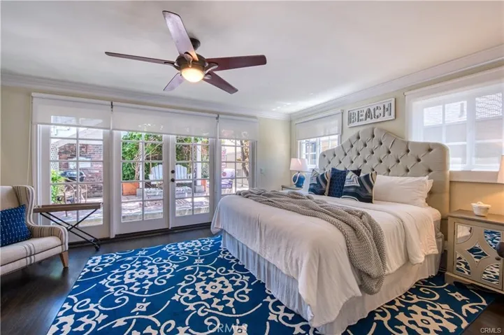 Main level guest bedroom with patio facing the rear of the property.
