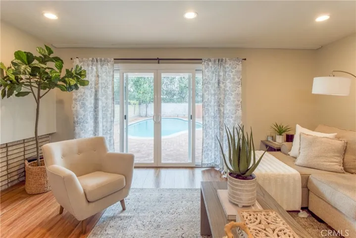 The living room features a wood-burning/gas-log fireplace and view of the amazing backyard