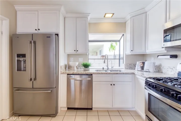The kitchen is appointed with stainless steel appliances (including the kitchen refrigerator) and a delightful garden window above the sink!