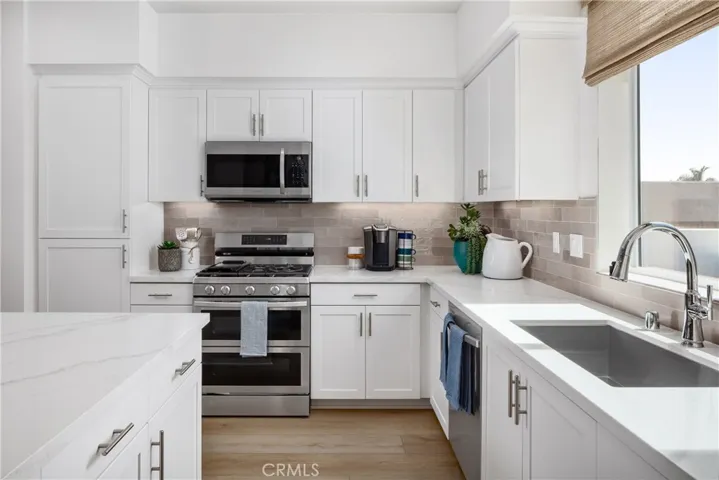 Enjoy quartz counters and full height tile splash at the kitchen.