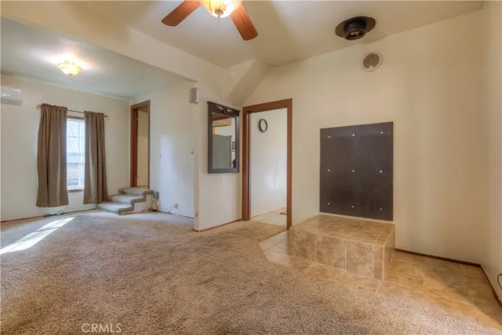 Living room with Tiered tile base for a wood stove.