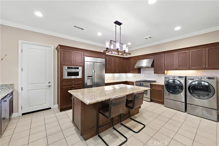 Full butler's kitchen with center island and laundry.