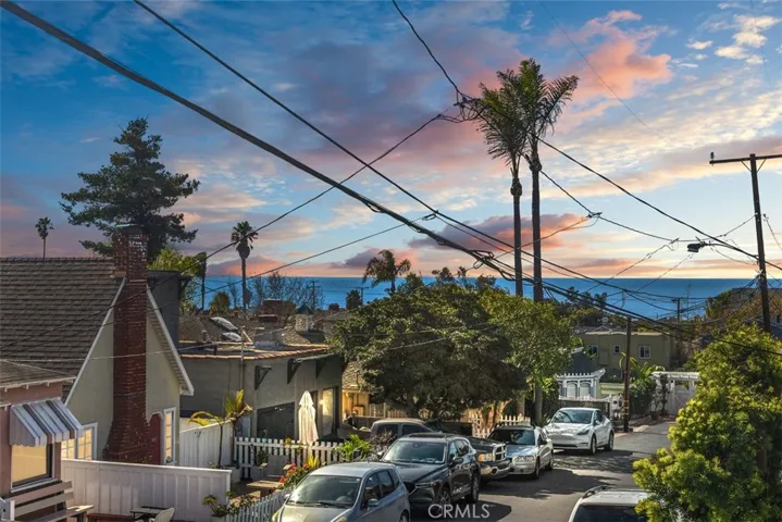 Street to street lot with sunset ocean views off upstairs deck area.