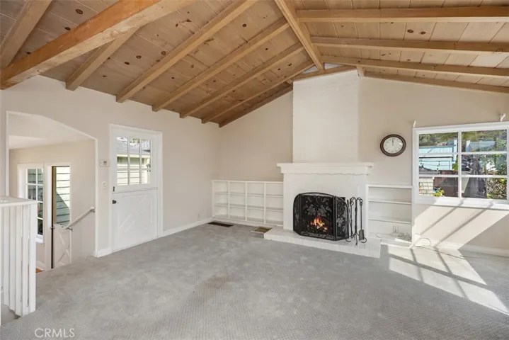 Another perspective of living room and dining room not staged.
