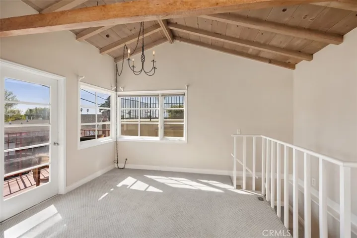 Patio door to upstairs deck space with ocean views not staged.