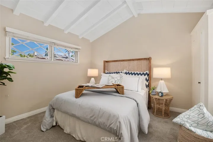 One of two main level bedrooms with built in closets staged.