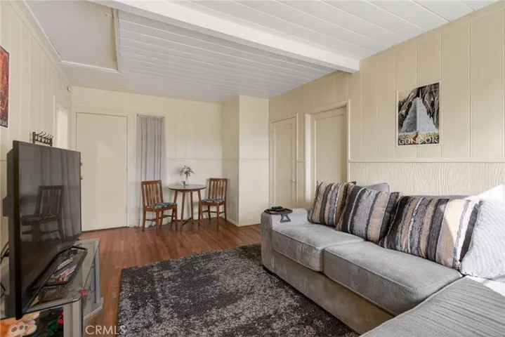 The ADU living room has ample space for sitting and dining areas. The entrance door is to the left of the dining table.