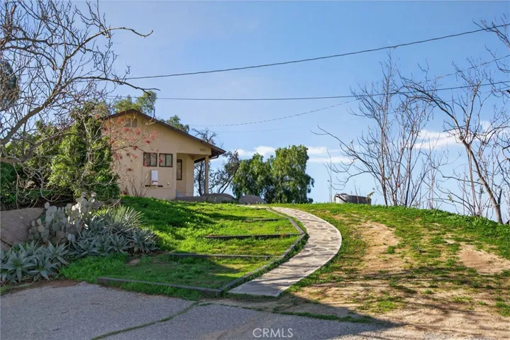 The landscaping has pathways that make access to all parts of the property convenient. This path leads from the main house to the garage and basketball court.