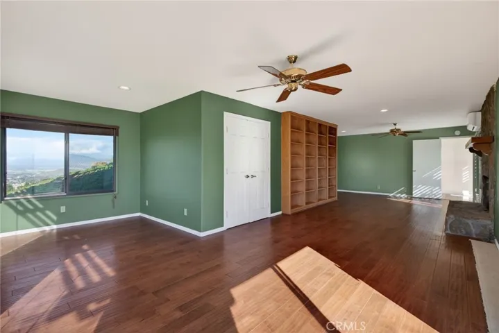 This view shows the full space including an alcove, walk-in closet and fireplace.