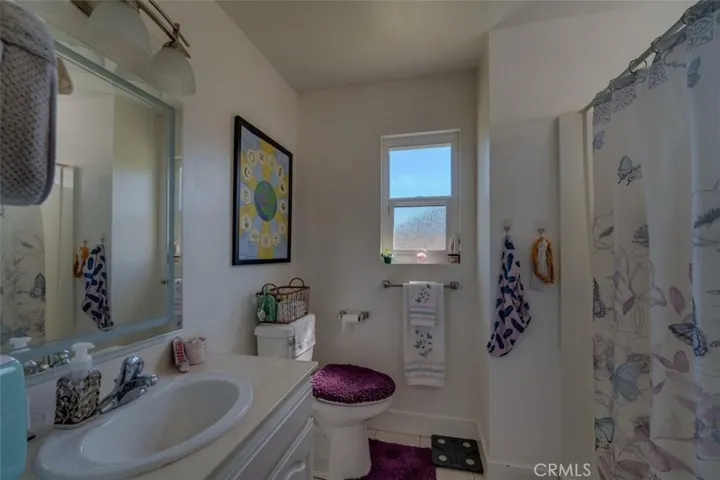 Downstairs primary bathroom.  Anti-fog mirror owned by Tenant and will be replaced by Seller's mirror upon move-out.