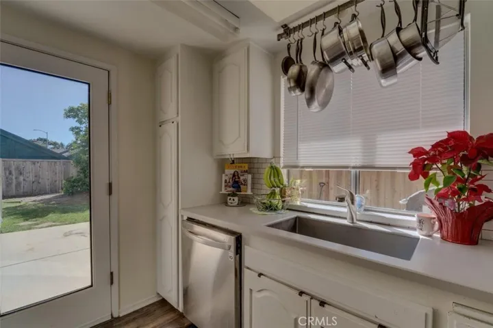 Kitchen door leads to large backyard patio.