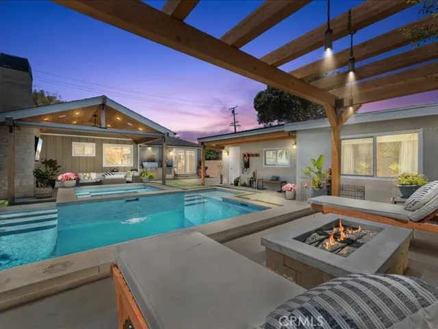 Relax by the firepit after taking a dip in your amazing pool with built in SPA .