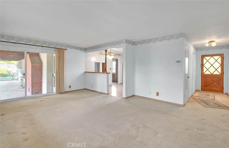 Formal living room with sliding doors that lead to the covered patio