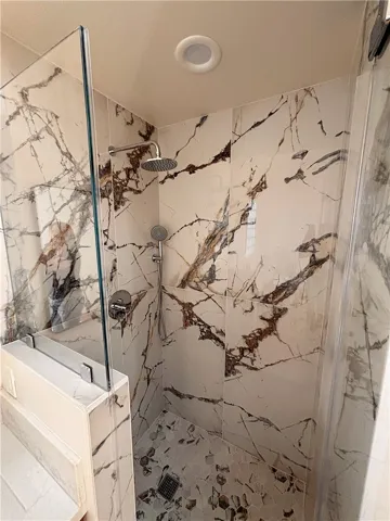 Walk-in shower in primary en suite bathroom