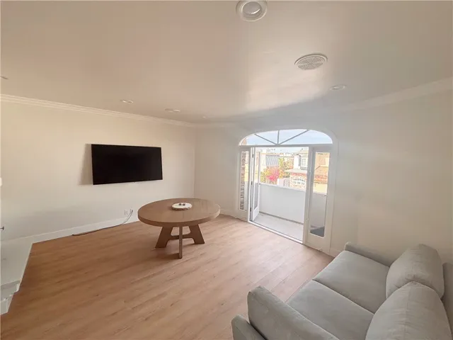 Living room view to deck and mounted flat screen TV (included). Sofa may be included. Dining table can also be included.