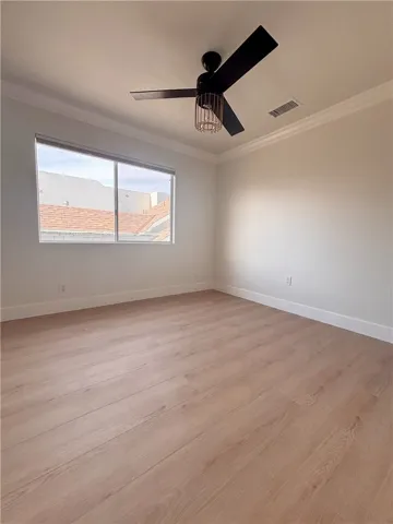3rd bedroom with ceiling fan -view from door