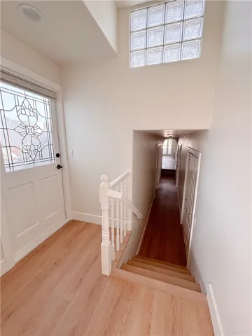 Landing door with leaded glass window leading to rooftop deck