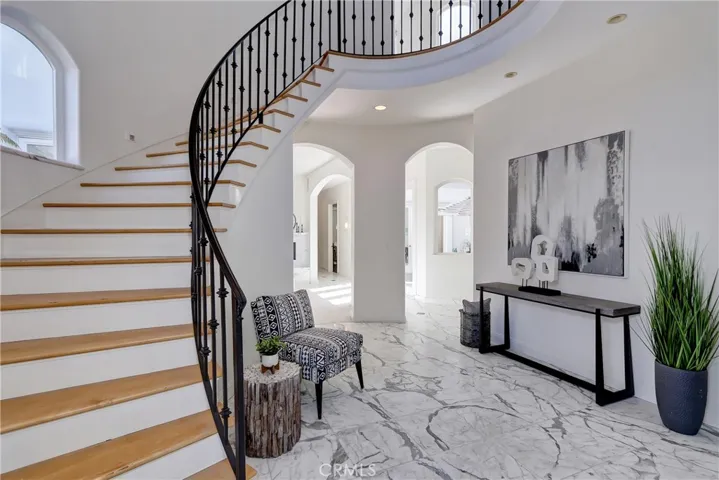 entry with two story spiral staircase