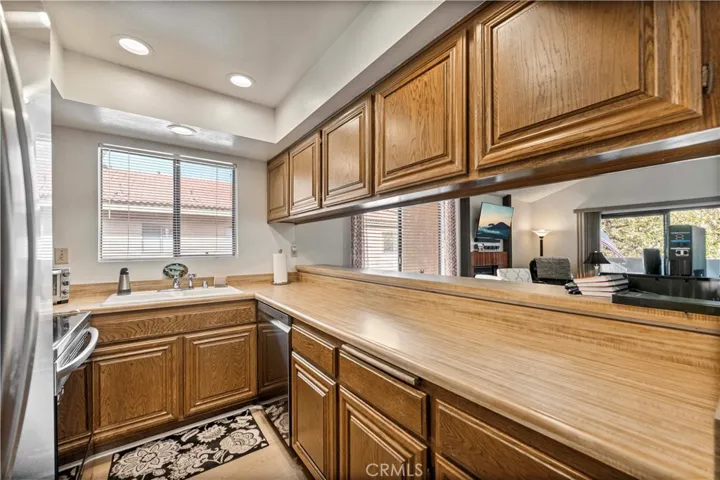 Super clean kitchen with recessed lighting opens to living room.