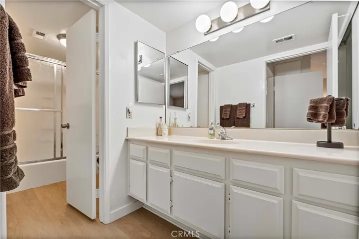 Large bright full bathroom has it's own private laundry.