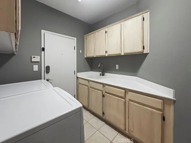 Laundry room with storage and utility sink