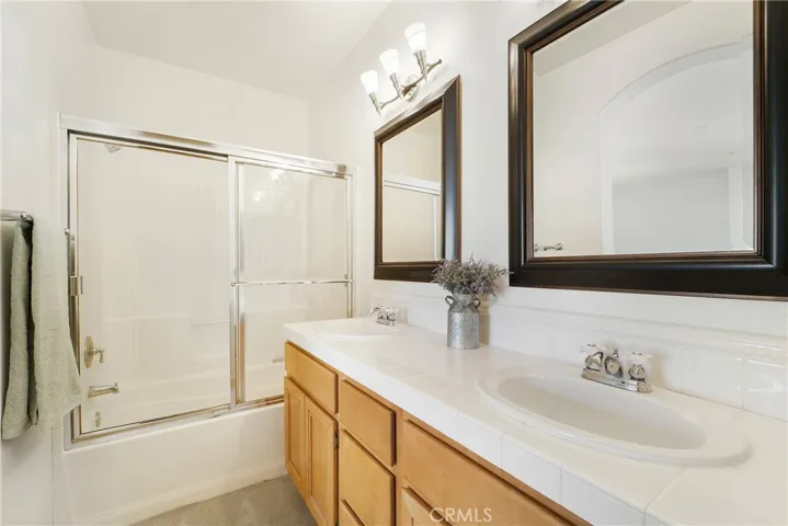 Dual vanities, tub, shower and linen storage in the owner's suite bath.