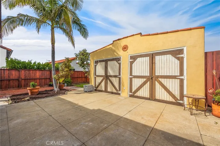 2 Car oversized garage with front driveway access and rear alley access.  portions of the garage converted to studio with sound proofing materials and an office