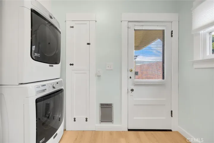 Utility room adjacent to kitchen with plentiful storage and laundry
