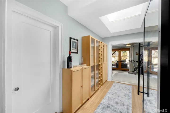 Breezeway to office with skylight and cabinets.