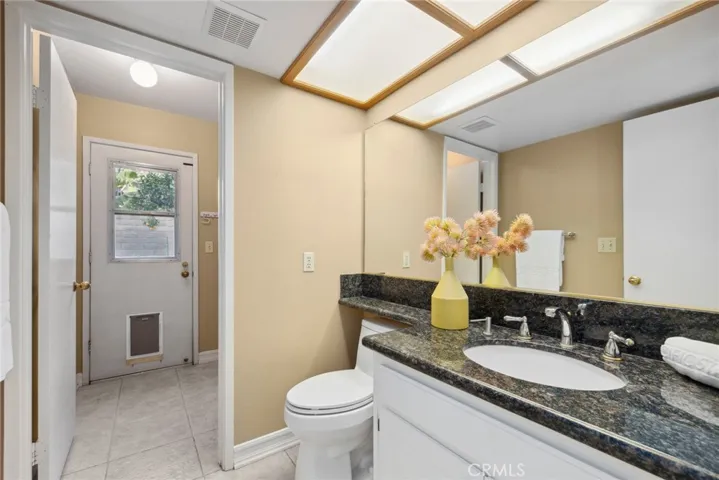 next to a half bathroom & large, downstairs laundry room w/ exterior door will help simplify life