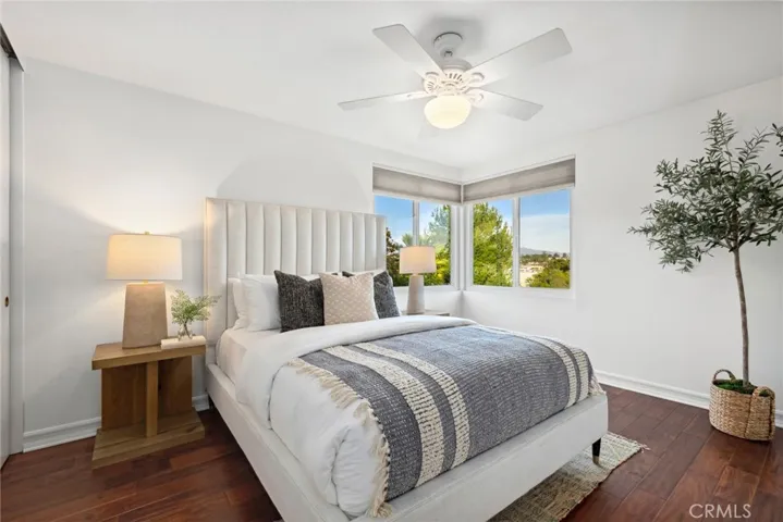 Upstairs bedroom w/ corner window & ceiling fan