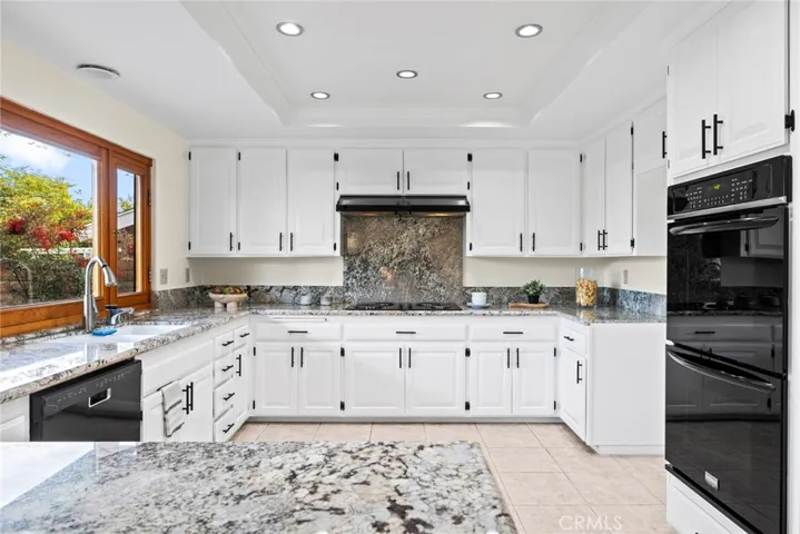 GE dual oven, recessed lighting, custom hood, HUGE walk-in pantry, upper & lower cabinets and a large oak window above the kitchen sink