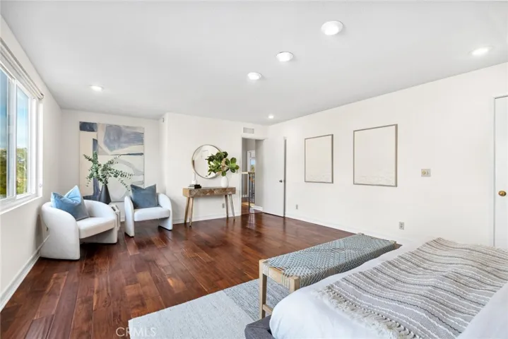 The generously sized bonus room boasts a cozy stone wall, recessed lighting & fresh white paint