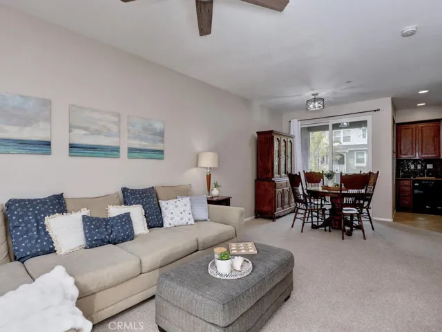 Living room open to dining area and covered deck at the back of the home