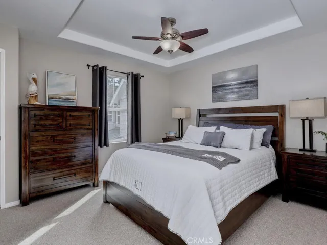 Main bedroom with ceiling fan and high ceilings