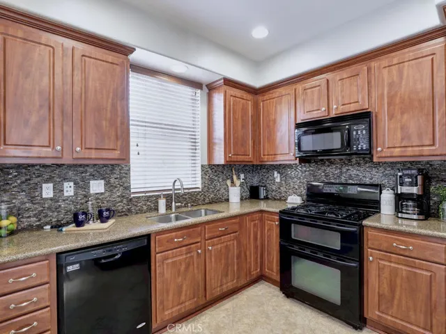 Bright kitchen with granite counters and generous cabinetry