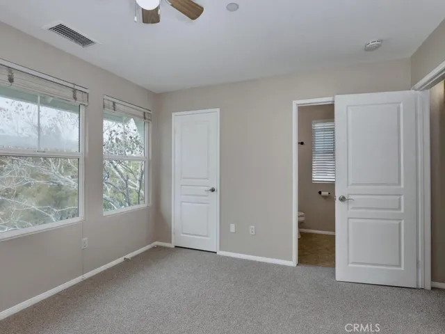 En suite bath in second bedroom with walk-in closet