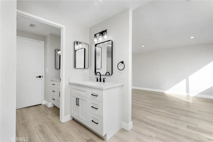 Remodeled bathroom w/ dual vanity sinks and shower/tub
