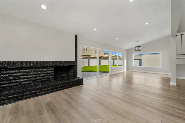 Enjoy a brick enclosed gas fireplace, large dual pane sliders and windows inviting in lots of natural light and a view of the large and private backyard.