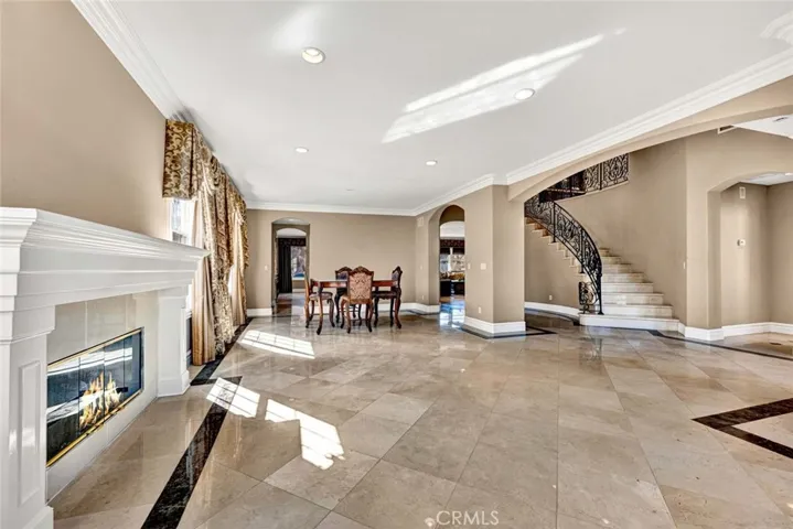 You see the foyer and sweeping staircase to the right abd the dining room beyond the living room. This enormous room allows you to turn the dining table perpendicular to the living room to easily seat 8 or more.