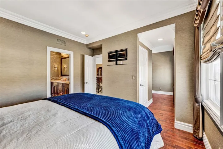 This angle shows the bath to the left of the picture, the entry door to the right of it, and through the other doorway are the closets and the cubby for a computer desk/home offer or reading room.